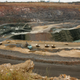 Trucks are loaded with rocks at the world's richest by production value open pit Diamond mine, Jwaneng, 160km south west of Gaborone on March 17, 2008. Botswana launches its own diamond trading company on March 18, 2008 in a move designed to boost local business and create jobs for citizens of the world's top producer of these precious stones. The creation of Diamond Trading Company Botswana (DTCB), a joint venture between De Beers and the Botswana government, will end the practice of sending diamonds mined in Botswana to De Beers' London-based main Diamond Trading Company for sorting and marketing. The pit is 350m deep and 2 kilometers wide. AFP PHOTO / ALEXANDER JOE (Photo credit should read ALEXANDER JOE/AFP/Getty Images)